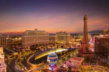 The iconic Las Vegas Strip lit up at night, featuring famous hotels and casinos